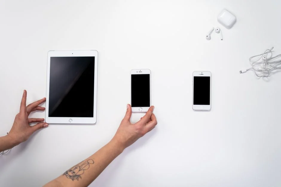 A contemporary workspace showcasing a laptop, tablet, and smartphones, ideal for tech and freelance use.